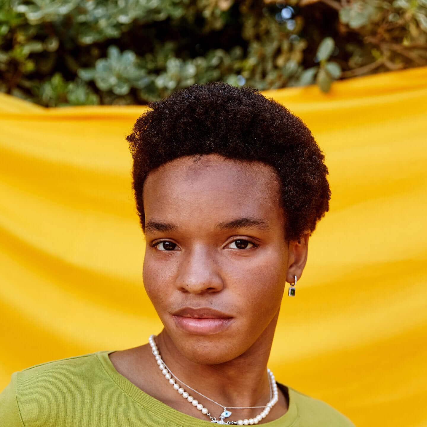 Close-up of a person in front of yellow backdrop.