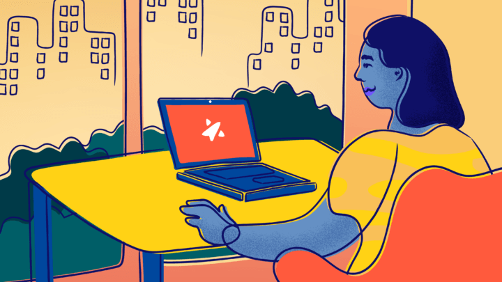 A smiling person logs on to Trevor's website on a laptop overlooking a city.