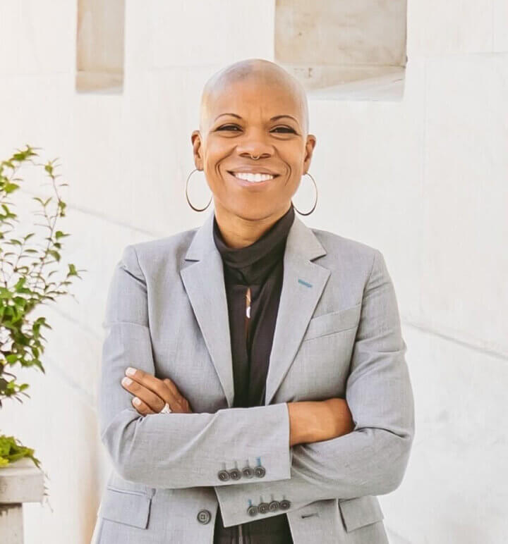 Picture of Jaymes Black posing with Grey Jacket with a blurred background.