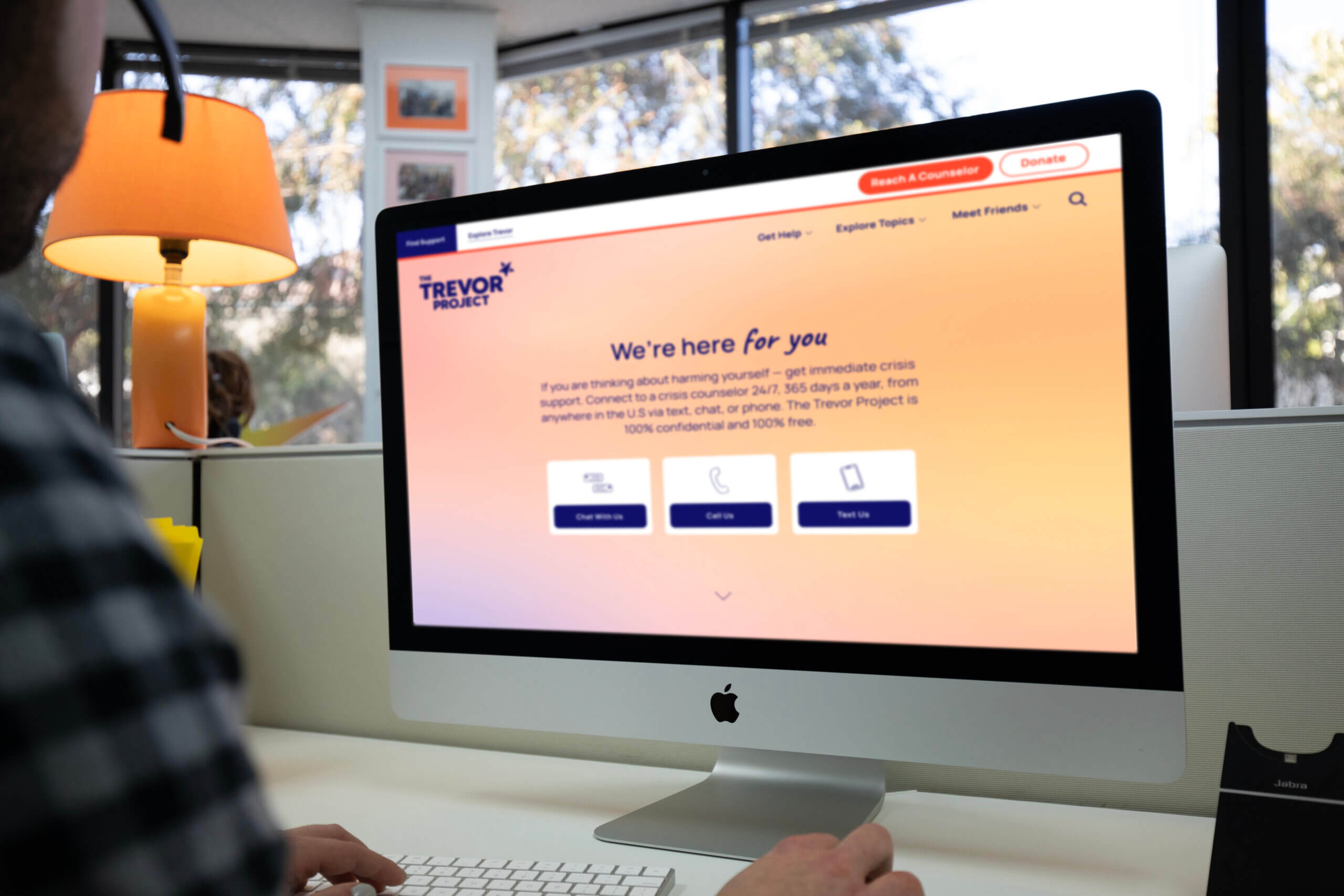 Close up of a person with a headset at computer screen